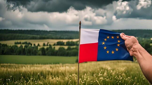 Flaga Polski i Unii trzymana w dłoni