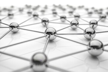 Abstract close-up of a network of interconnected shiny metal spheres on a reflective surface, symbolizing connection and technology.