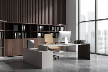 Stylish office interior with ceo desk near window, pc computer and shelf