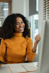 Overjoyed charming excited black woman business woman worker using tablet and laptop working in office, feeling happy.