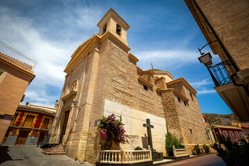 Fototapeta premium View of the baroque parish of Santiago Apóstol in the town of Pliego, Region of Murcia, Spain with its bell tower in the foreground