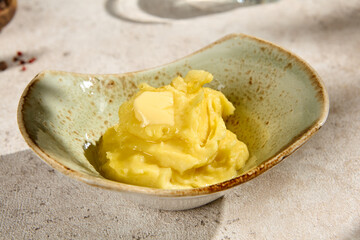 Sunlit Creamy Mashed Potatoes with Butter in Summer Shadows