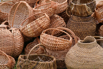 A pile of baskets and vases made of wicker
