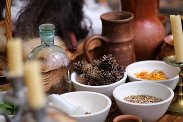Spices are in bowls on a vintage table with fir cones