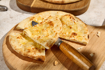 Cheese Focaccia on Wooden Board in Sunlight with Shadows - Summer