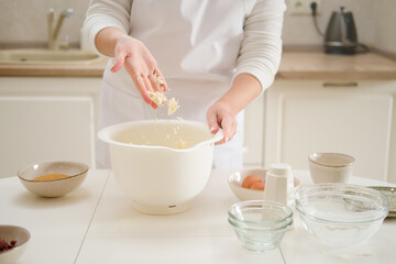 Close up of woman hands kneading dough in a bowl. Process of cooking pecan pie in home kitchen for American Thanksgiving Day.