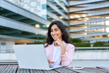 Focused young middle eastern Israel businesswoman using laptop pc online application for work...