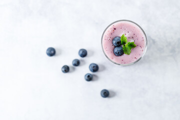 Blueberry smoothie with yogurt in a glass.