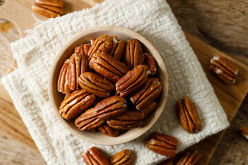 Pecan nuts in a wooden bowl