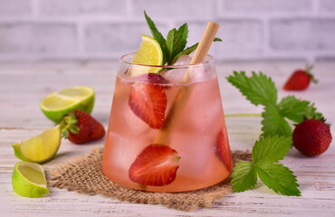 Mojito with strawberries and lime. Refreshing summer drink.Close-up.
