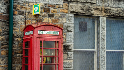 Fototapeta premium An old telephone box housing a local life saving defibrillator