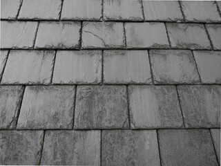 Close-up of a grey slate tile roof showing texture and detail of the overlapping, weathered tiles.