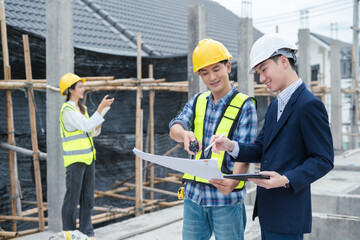 engineers or business partners on a construction site, discussing project details.