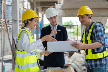engineers or business partners on a construction site, discussing project details.