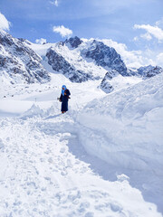 Tranquil Winter Wanderlust: Girl Walking in Snowy Mountain Scenery