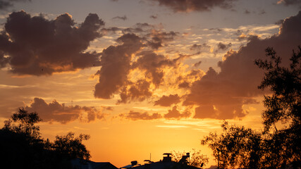 Golden sunset clouds creating a stunning backdrop, symbolizing warmth and serenity.
