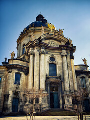 Religious Artistry: Weathered exterior of a church with ornate stonework, in daylight. The...