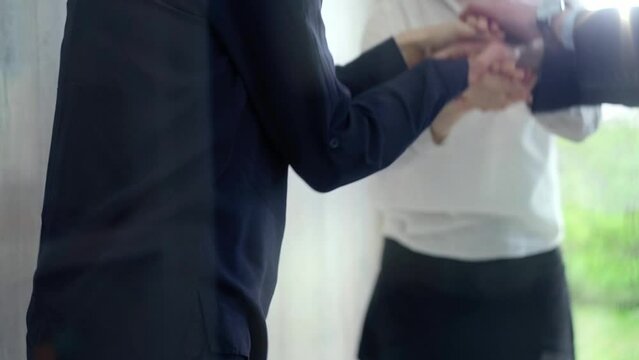 Team unity - business hand stack. Close-up of a diverse team stacking hands, symbolizing partnership and teamwork