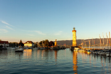 Fototapeta premium The harbor of Lindau at the Lake Constance with lighthouse and statue of bavarian lion. Germany