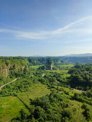 expanse of green hills and blue skies during the day, beautiful views from the top of the name Puncak Taruko Bukittinggi, Indonesia