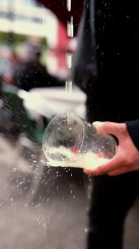unrecognizable man holding a crystal glass in his hand and pouring Asturian apple cider over it. Tradition from the north of Spain. Typical alcoholic beverage from Asturias, Spain.