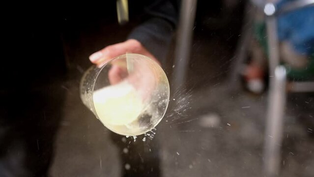 unrecognizable man holding a crystal glass in his hand and pouring Asturian apple cider over it. Tradition from the north of Spain. Typical alcoholic beverage from Asturias, Spain.