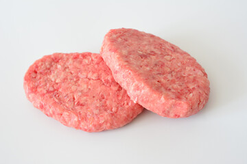 two raw hamburgers made of beef meat close up 