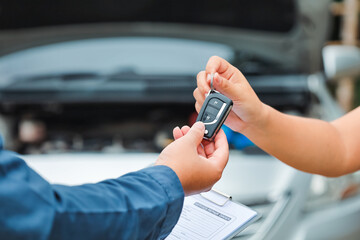 Car care and service A technician is troubleshooting an engine. Spare parts of car engines that have problems and support car insurance services, standard car repair service center concepts.