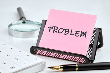 PROBLEM text on a pink sticker in a composition with business accessories