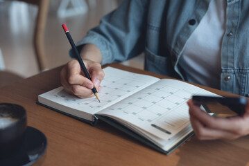 Event planner timetable agenda plan on year 2024 schedule event. Business woman checking planner on...