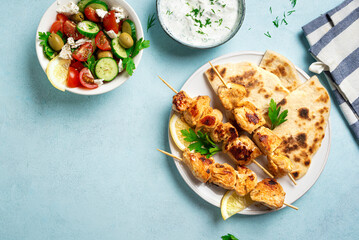 Chicken souvlaki kebabs and greek salad