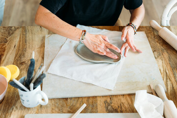 Ceramic workshop. Artistic hands working on clay creations