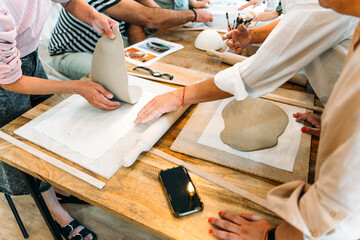 Ceramic workshop. Collaborative pottery session with clay tools