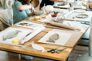 Ceramic workshop. Pottery enthusiasts creating clay designs together