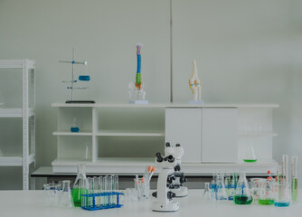scientific instruments beaker test tube and microscope for analyze scientists was placed on white...