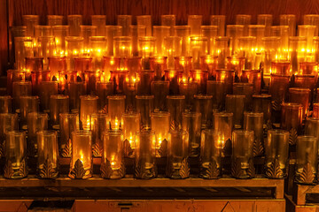 abstract background of burning candles in the church