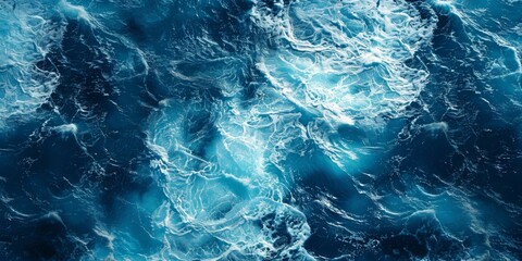 Obraz premium A spectacular aerial top view photo captures the backdrop of ocean sea water, with white waves splashing in the deep sea. This drone photo provides a bird's-eye view of the dynamic waves