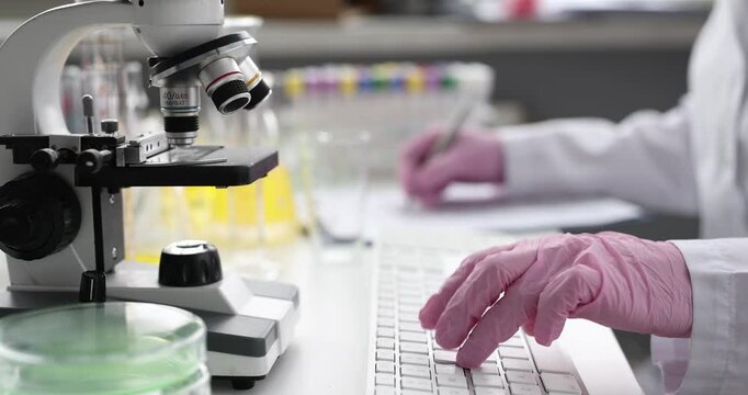 Doctor laboratory diagnostics recording result of analysis in computer database closeup 4k movie. Modern scientific technologies concept