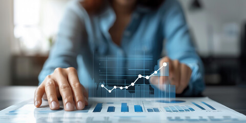 A businesswoman analyzes data and trends on a digital screen, utilizing AI technology to enhance insights and make informed decisions