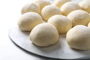 Many raw dough balls on white table