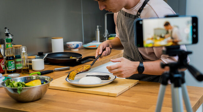 The chef is broadcasting live from workshop how to prepare a grilled eggplants with garlic - Powered by Adobe