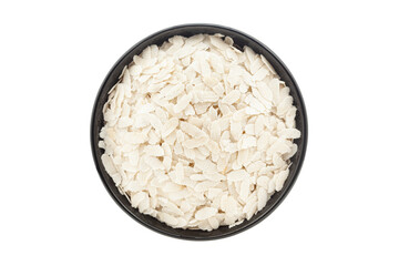 Organic Flattened Rice (Oryza Sativa) or Poha, in a black ceramic bowl. Isolated on a white background. Top View