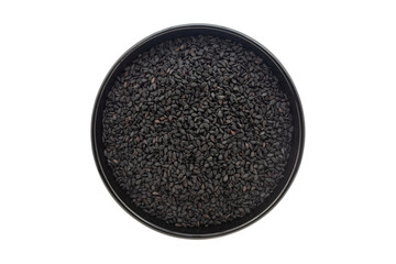Organic Black Sesame (Sesamum indicum) Seeds, in a black ceramic bowl. Isolated on a white background. Top View