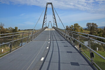 Fototapeta premium Cycle bridge to Slovakia over Morava river at Marchegg in Austria, Europe 