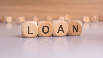 wooden blocks with text loan, brown background