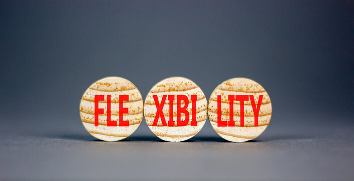 Flexibility symbol. Concept word Flexibility on beautiful wooden circles. Beautiful grey table grey background. Business flexibility concept. Copy space.