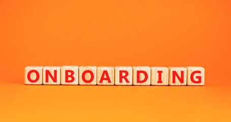 Onboarding success symbol. Concept word Onboarding on wooden blocks. Beautiful orange background. Business onboarding success concept. Copy space.