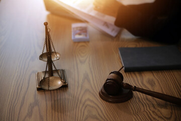 Judge gavel with Justice lawyers having team meeting at law firm background. Concepts of Law and Legal services.