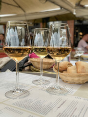 three glasses of wine on table in a cafe or restaurant 