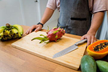 Chef cuts and peels dragon fruit on the cutting board